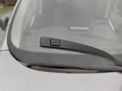 Wiper arm with a wider push-button end, blade removed